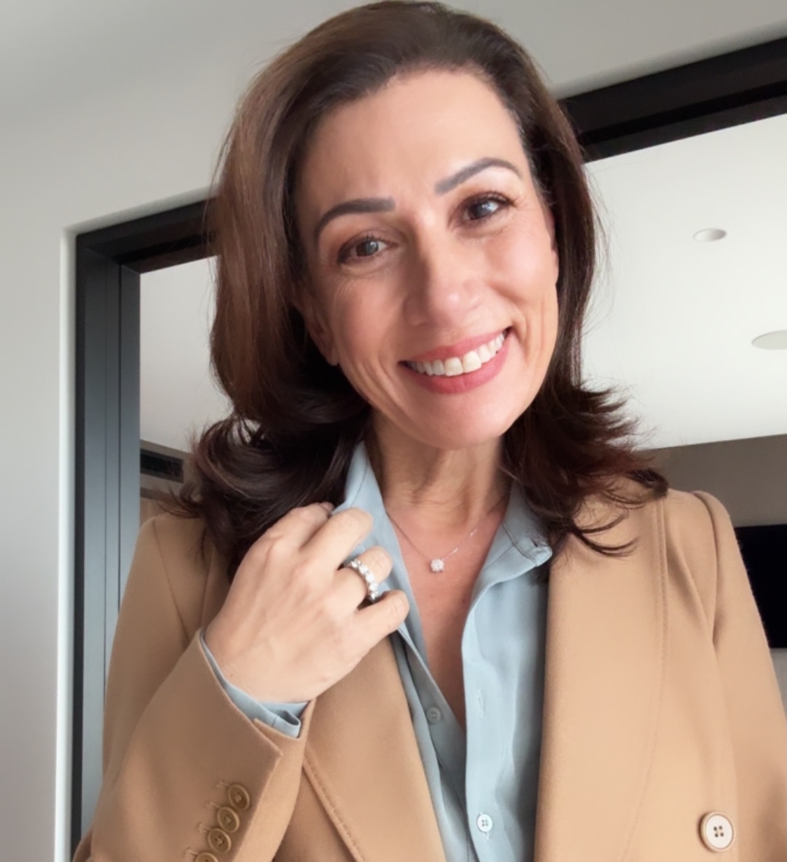A Camel Blazer with a Pale Blue Blouse for Refined Professional Style